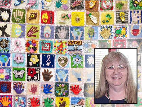 Beaded wall hanging has multiple square beaded sections, each with a hand motif. A blond woman is pictured at the bottom left.