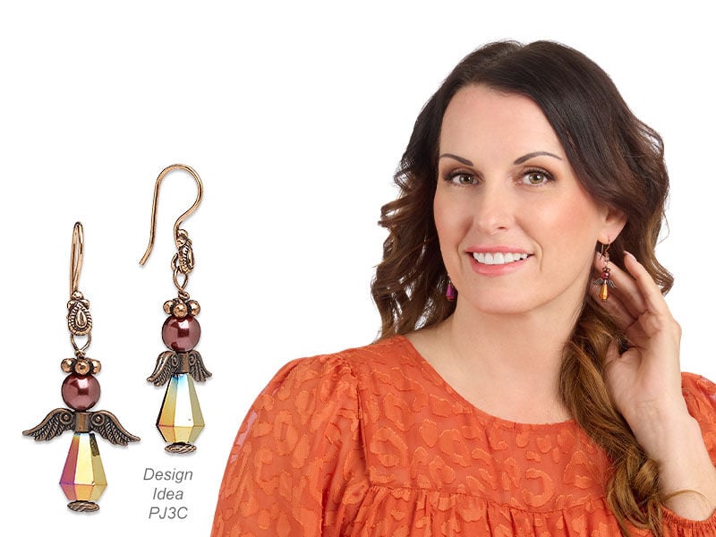 Model wearing angel earrings made with metal angel wings