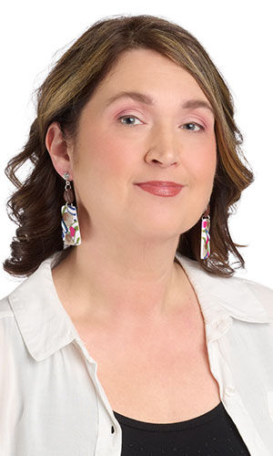 Woman in a white blouse and black tank top wearing Design Idea S A 2 X caf&eacute;-themed stud earrings.