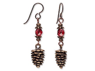 Design Idea R B 2 9 - Fishhook earrings each have a dark red faceted glass bead between coppery bead caps and a coppery pinecone charm at the bottom.