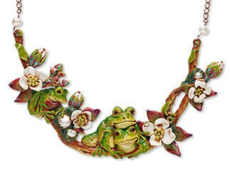 Design Idea E B 0 3 - Chain necklace has a wide, shiny polymer clay centerpiece of realistic green frogs and white cherry blossoms on a brown branch.