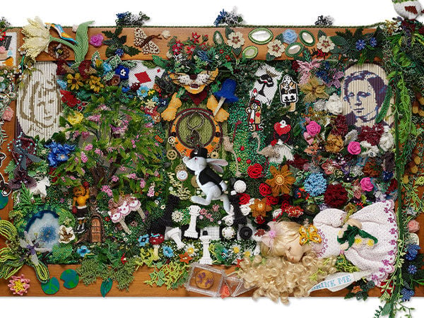 Elaborate 3D beaded mural featuring multiple elements from Alice in Wonderland, including chess pieces, a rabbit, playing cards, flowers and more.