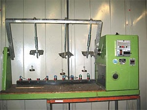 Figure 3: Wire ''Flexing'' machine used for 5,000 flexing operations. Illustration depicts samples as suspended with 1/2lb weight.