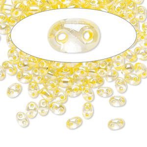 Seed bead, Preciosa Twin&trade; Czech glass, pkg/50g, 5x2.5mm oval, transparent yellow terra color-lined clear, (38686).