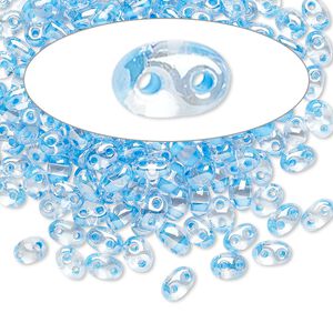 Seed bead, Preciosa Twin&trade; Czech glass, pkg/50g, 5x2.5mm oval, transparent sky blue terra color-lined clear, (38665).