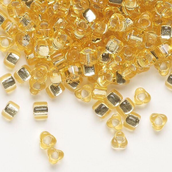 Seed bead, Miyuki, glass, silver-lined translucent gold (TR1102), #5 triangle. Sold per 250-gram pkg. image number 0