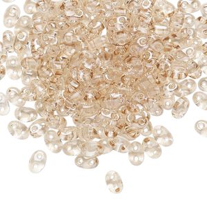 Seed bead, Preciosa Twin&trade; Czech glass, pkg/10g, 5x2.5mm oval, transparent honey crystal clear, (20201).