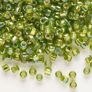 Seed bead, Dyna-Mites&trade;, glass, silver-lined translucent rainbow light green, #6 round with square hole. Sold per 40-gram pkg.