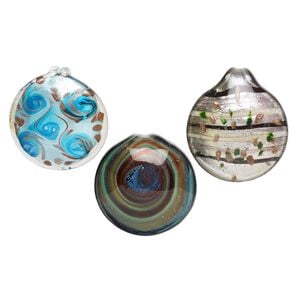 Random focal mix, lampworked glass, opaque to transparent mixed colors, 43mm-55mm domed round with silver-colored foil and copper-colored glitter. Sold per pkg of 3.