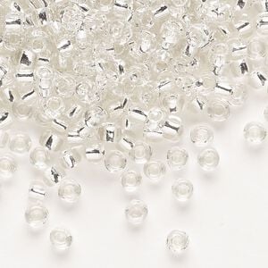Seed bead, Dyna-Mites&trade;, glass, transparent silver-lined clear, #6 round. Sold per 1/2 kilogram pkg.
