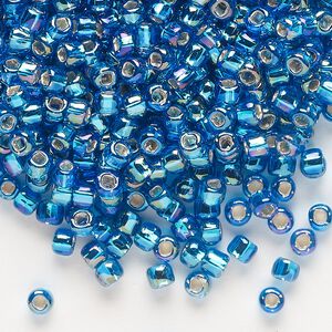 Seed bead, Dyna-Mites&trade;, glass, silver-lined translucent rainbow turquoise blue, #6 round with square hole. Sold per 1/2 kilogram pkg.