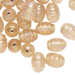 Bead, lampworked glass, translucent light peach luster, 11x9mm-13x9mm ribbed oval. Sold per pkg of 50.
