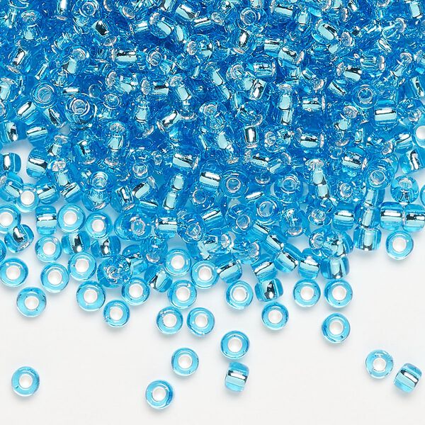 Seed bead, Dyna-Mites&trade;, glass, silver-lined translucent aqua, #8 round. Sold per 40-gram pkg. image number 0