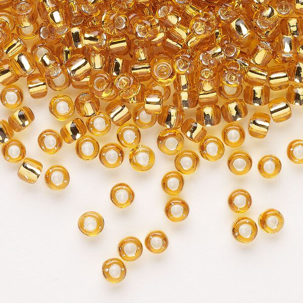 Seed bead, Dyna-Mites&trade;, glass, transparent silver-lined gold, #6 round. Sold per 1/2 kilogram pkg. image number 0