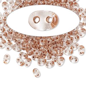 Seed bead, Preciosa Twin&trade; Czech glass, pkg/50g, 5x2.5mm oval, transparent copper color-lined clear, (68105).
